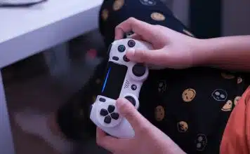 person holding white sony ps 4 controller